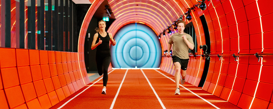 Students running in colorful tunnel