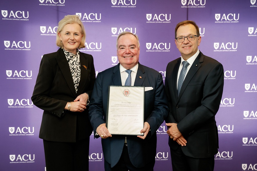 photo of three people holding a framed parchment