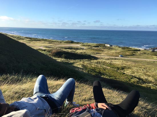  Louise Poole and friend relaxing outside whilst overlooking the ocean.